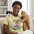  Lady sitting on a sofa in a living room wearing Personalized Cats Are A Girl's Best Friend T-shirt with custom woman character and up to 5 cats - Yellow T-shirt, with three cats nearby