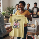 Woman holding a yellow t-shirt Personalized Cats Are A Girl's Best Friend T-shirt with custom woman character and up to 5 cats with a cat-themed design in a living room with people and cats.