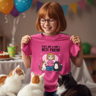 Girl holding a pink custom cat lover girls t-shirt featuring personalized child and pet cat characters with names, surrounded by cats in a celebratory setting.